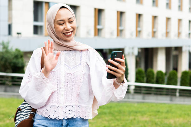 istock Happy woman using smartphone outdoors 1875950516