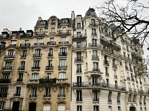 Parisian typical building facade on winter day, historical fashionable building in chic and rich quarter of the French capital city