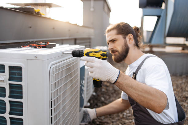 istock Male worker repairing conditioner while using drill outdoor 1875959403
