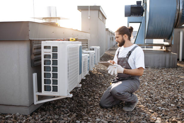 istock Repairman working with conditioner and using tablet on plant 1875959406