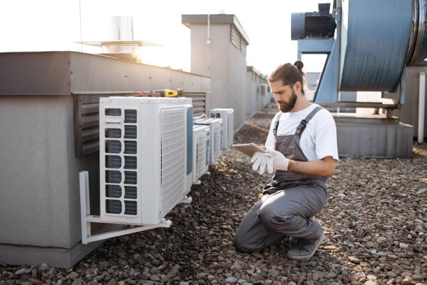 istock Repairman working with conditioner and using tablet on plant 1875959411