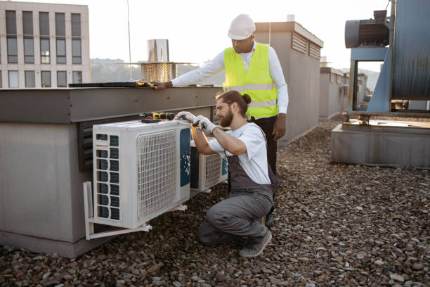 istock Diverse plant workers repairing air conditioner on rooftop 1875959962
