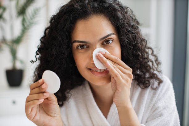 istock Multiracial woman removing cosmetics from nose area 1875961091