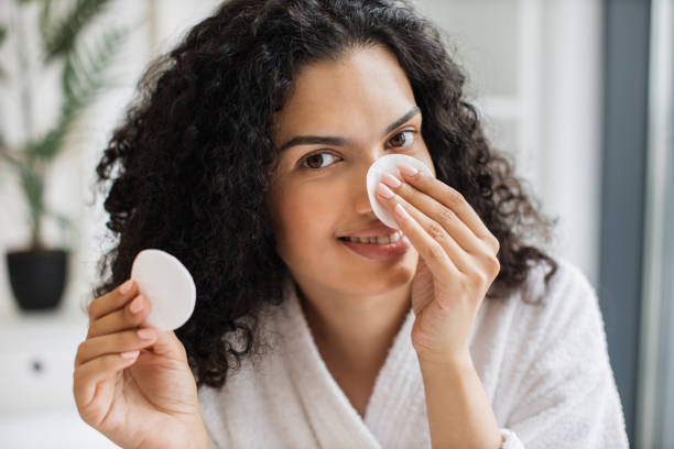 istock Multiracial woman removing cosmetics from nose area 1875961101