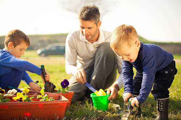 istock Family planting flowers 187597186