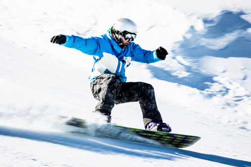 Young man snowboarding. Copy space.