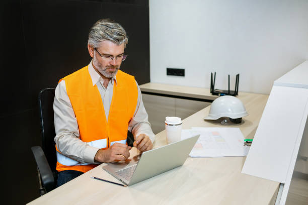 istock automation engineers in safety vest using laptop for inspection and projects 1875980290