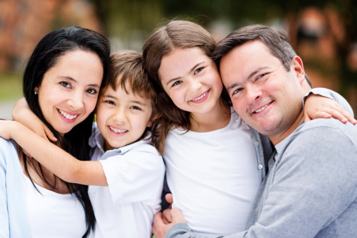 Portrait of a happy family smiling at the park