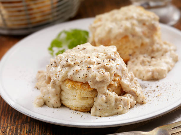 Biscuits and Gravy Homemade Biscuits with Sausage Gravy- Photographed on Hasselblad H3D2-39mb Camera gravy stock pictures, royalty-free photos & images