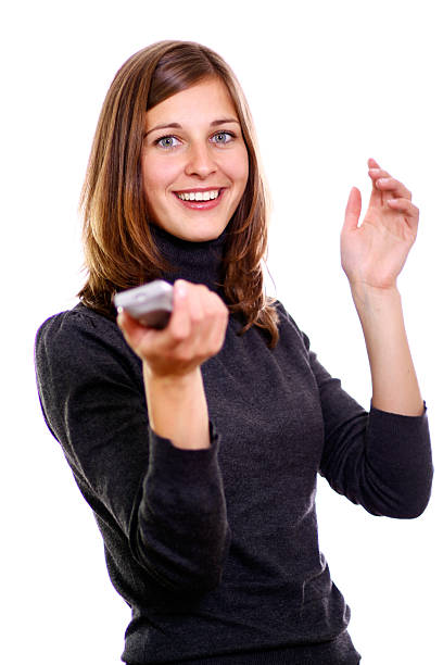 istock Happy woman holding TV remote control, over white background 187599980