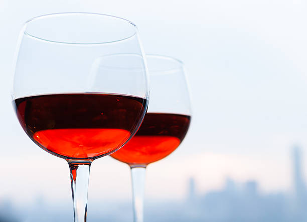 istock Glasses of wine against city skyline 187601093