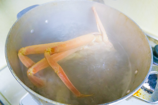 It looks like live crabs are being boiled, and there is a lot of steam.