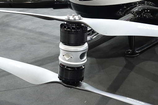 Close-up of drone propellers and brushless motor. Big propellers blades. Drone maintenance.