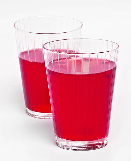 Two red cranberry fruit drinks Two red cranberry fruit drinks in the glass. marshwort stock pictures, royalty-free photos & images