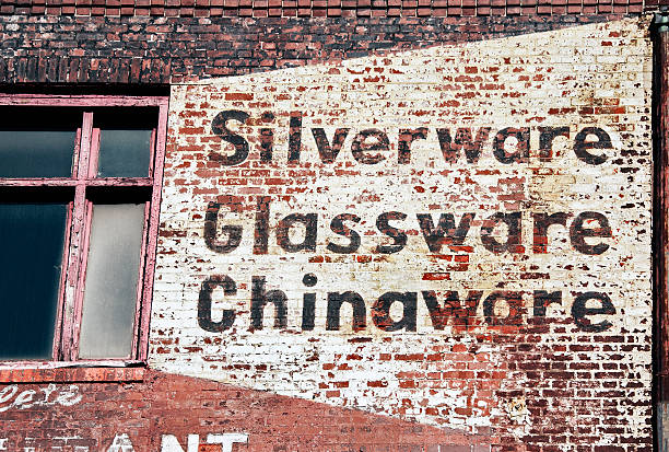 Old company's sign painted on bricks of building remodeled to office and residential space in downtown Minneapolis MN