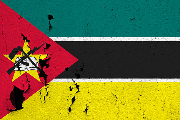 Flag of Mozambique The flag of Mozambique painted on a cracked and peeling wall. construction material torn run down concrete stock pictures, royalty-free photos & images