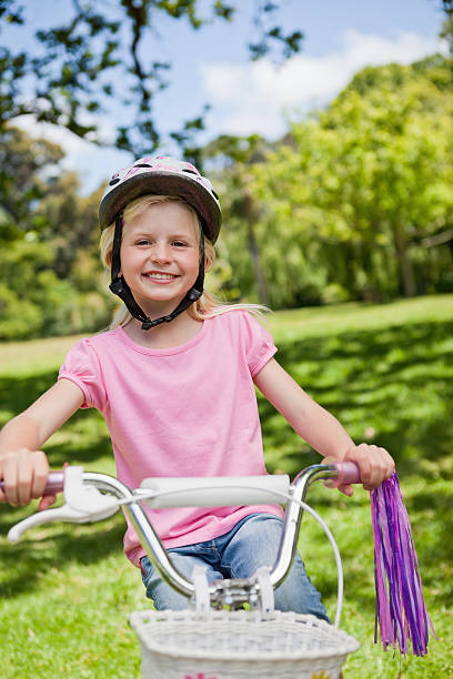 istock Smiling girl riding her bicycle 187611327