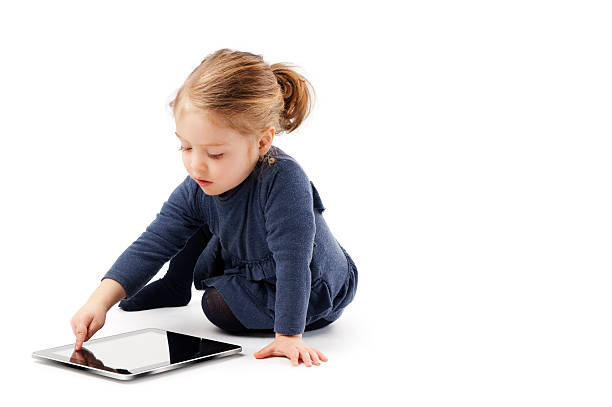 istock Little Girl Crouching With A Tablet Computer.Color Image 187612439