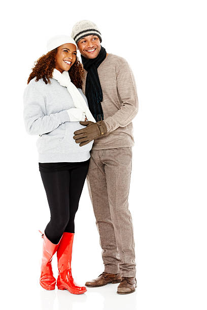 istock Happy pregnant couple in warm clothes looking at copyspace 187613041