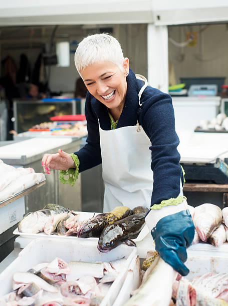 fish market - mature woman having fish bildbanksfoton och bilder