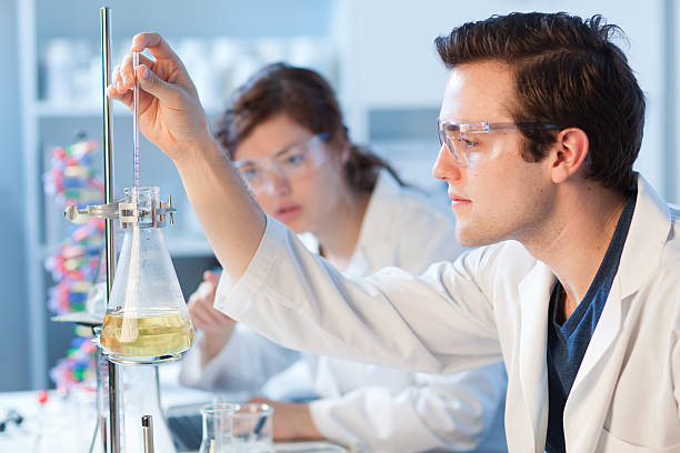 istock Laboratory Researcher Team Working on Chemistry Experiment, Observing Container Horizontal 187613395