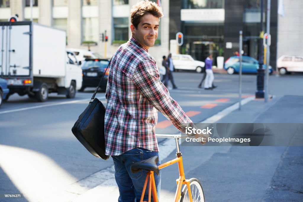 Like my two-wheeled ride? A young man with his bicycle in the city Men Stock Photo