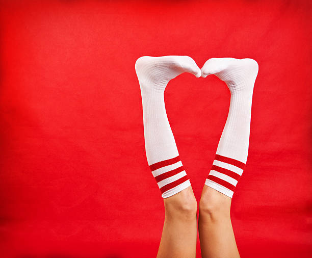 Woman's Legs In Tube Socks Making Heart Shape stock photo
