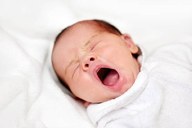 istock Newborn baby yawns 187616097