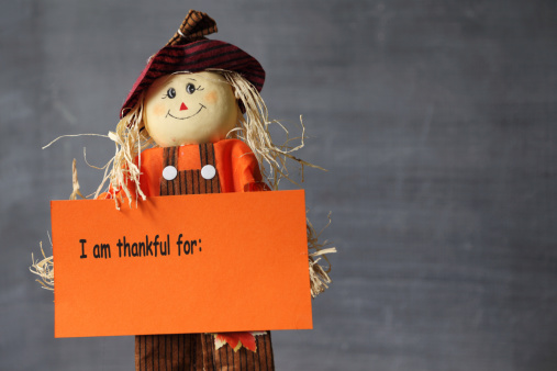 Happy scarecrow holding a sign 