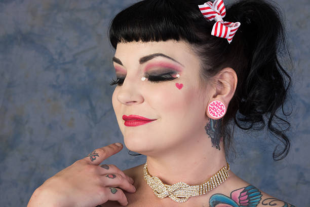 istock Woman in doll makeup, eyes closed, hand on shoulder. 187616362