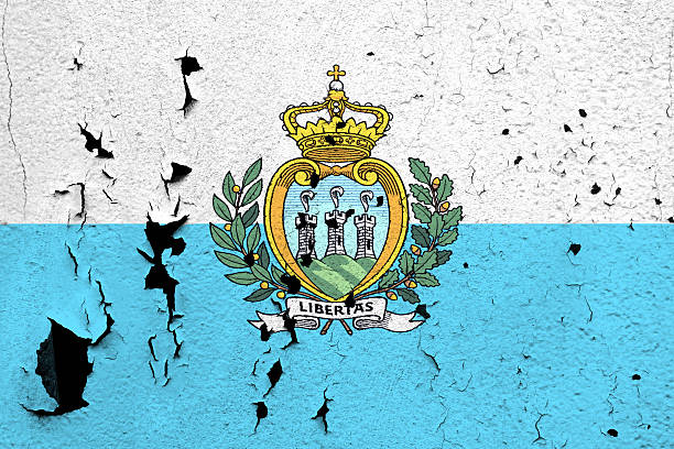The flag of San Marino painted on a cracked and peeling wall.