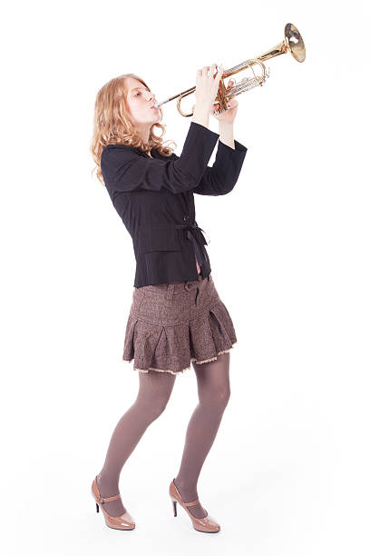 istock young pretty woman playing the trumpet 187618598