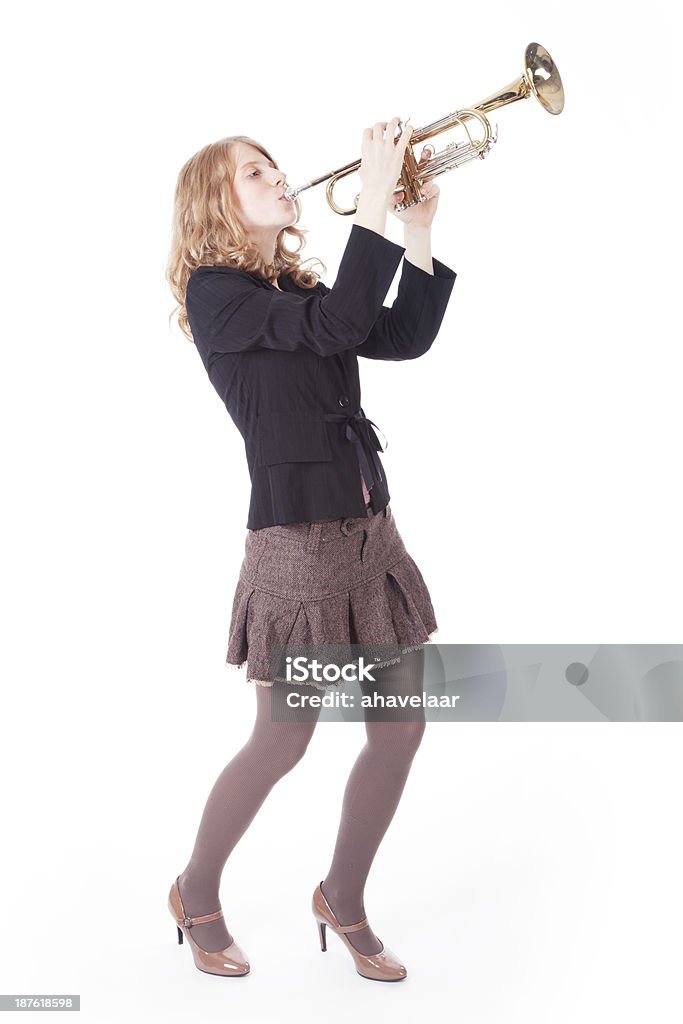 young pretty woman playing the trumpet young pretty woman playing the trumpet against white background Trumpet Stock Photo