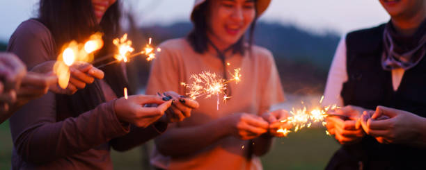 istock Group of Asian people playing sparkling firework. 1876189741