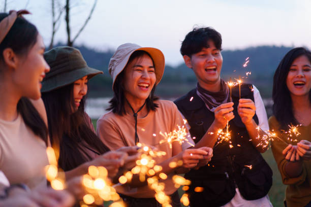 istock Group of Asian people playing sparkling firework. 1876189742