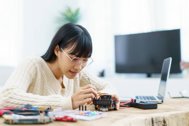 istock Asian woman working on electronic part. 1876190764