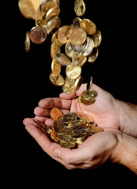 Photo of Man Hands full of money receiving a  Coins Rain