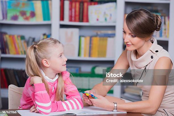 Child Psychologist Talking To Little Girl At Her Office Stock Photo - Download Image Now