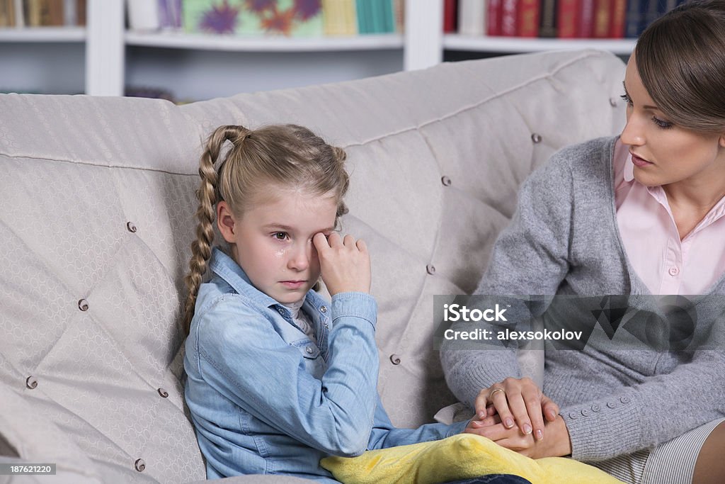 Child psychologist with a little girl Child psychologist with a little girl, a child is crying Negative Emotion Stock Photo