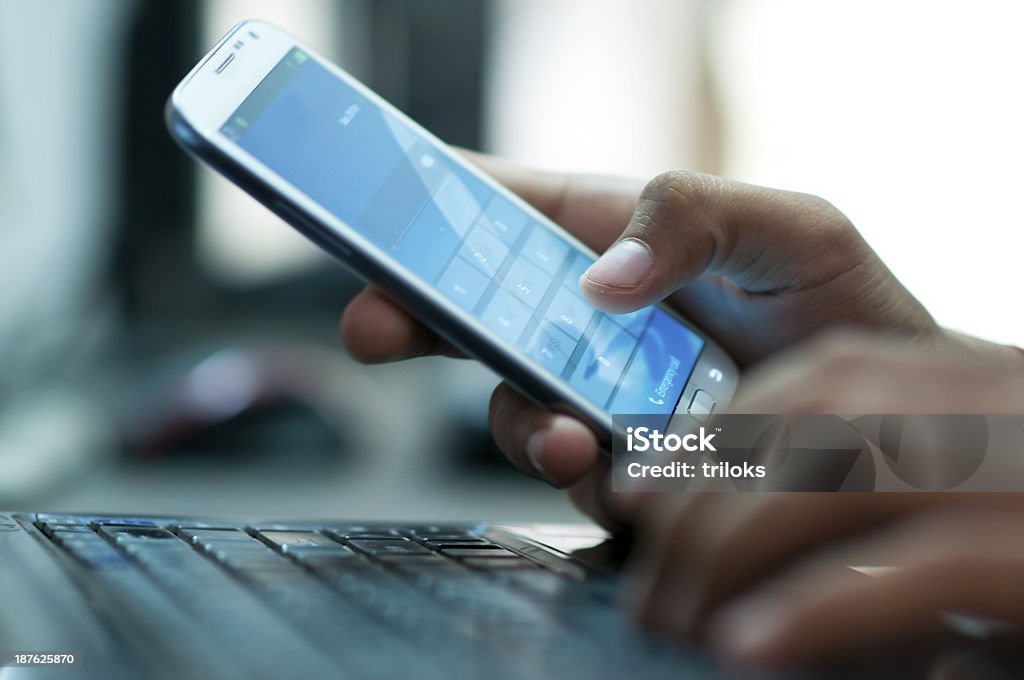 Businessman hand using laptop and mobile phone in office Businessman using smart phone Mobile Phone Stock Photo