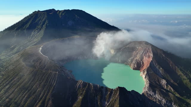 Aerial view drone orbit around to reveal Kawah Ijen volcano crater, Java, Indonesia