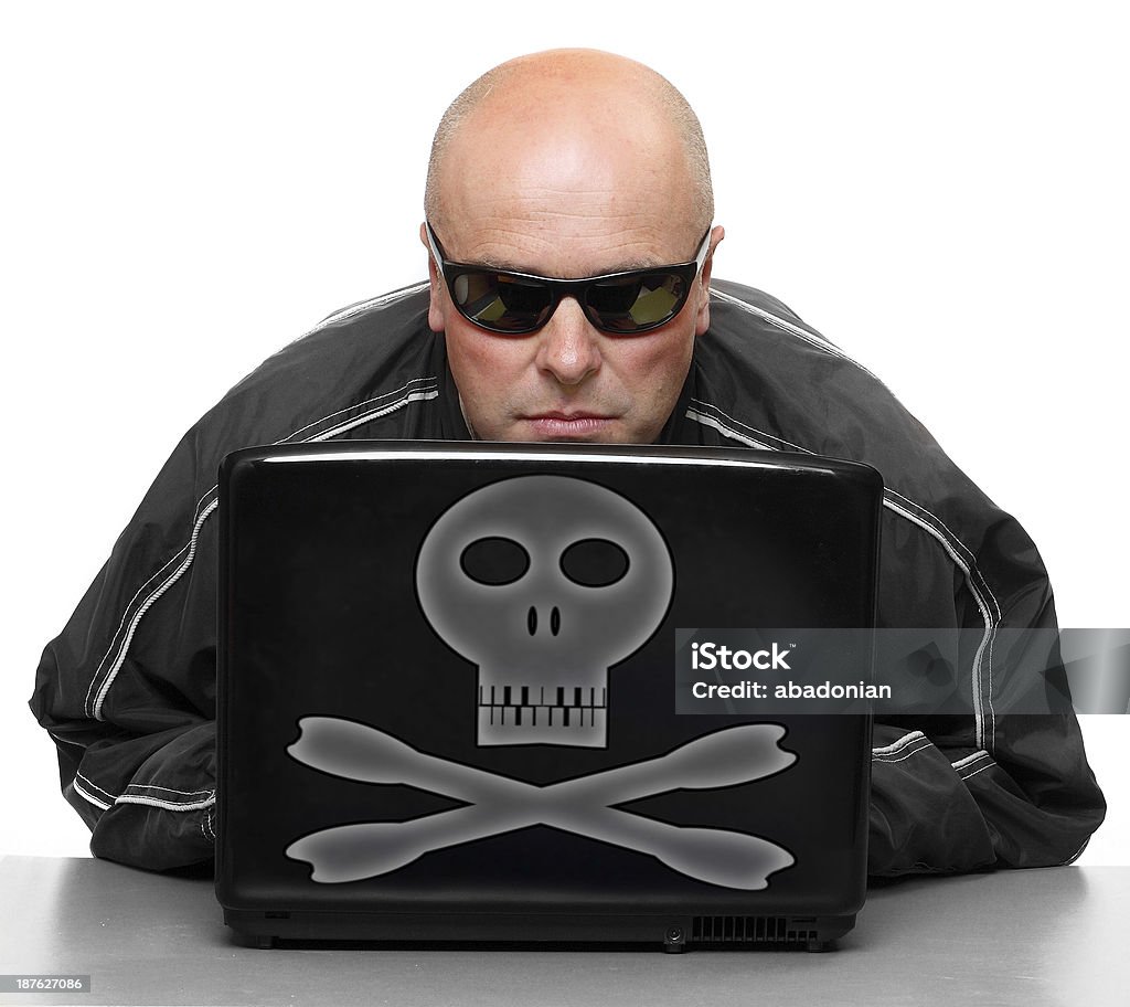 Dangerous hacker with laptop. Online crime metaphor. Adult Stock Photo
