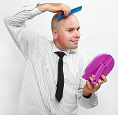 Hairless businessman with mirror.