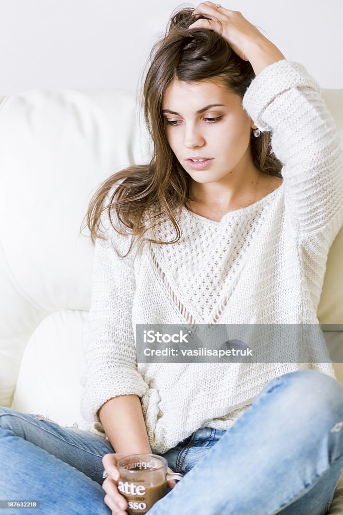 Young lady Cute girl on sofa with a cup Adult Stock Photo