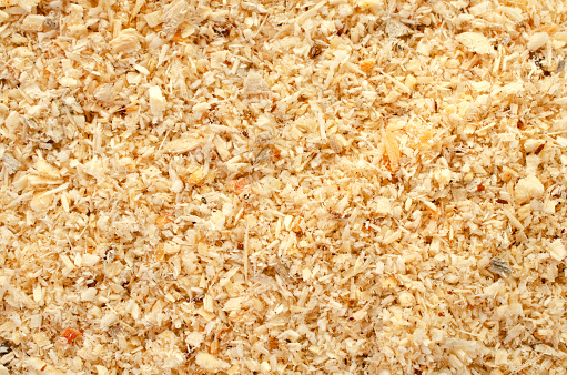 Wood sawdust, background, texture, top view. Pile of sawdust, background. Heap of wood shavings, background, texture, top view