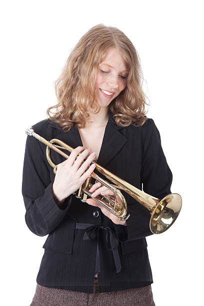 istock young pretty woman holding trumpet 187635527