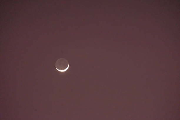 istock crescent moon in the evening sky. Hilal. 1876407513
