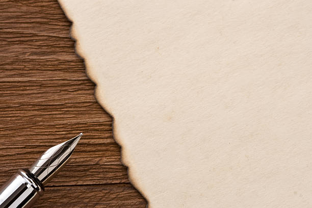 istock ink pen and parchment on wood 187641040