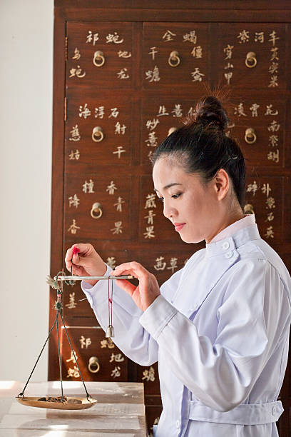 Doctor Weighing Herbal Medicine with Scale