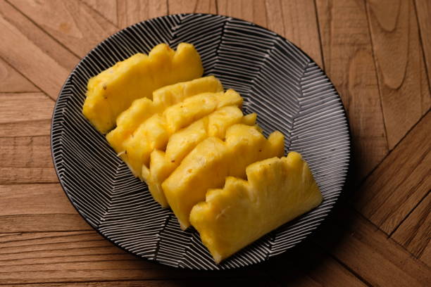 istock pineapple slices on a red ceramic plate. Ananas comosus. tropical fruit 1876413634